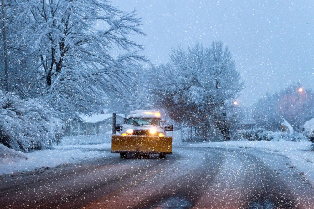 AdobeStock_216014922 (1) Snow Plow On a Snowy Winters Night